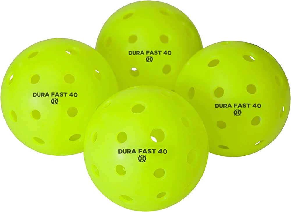 A product image showing four neon yellow Dura Fast 40 pickleballs, a durable and popular option for outdoor tournament play. 