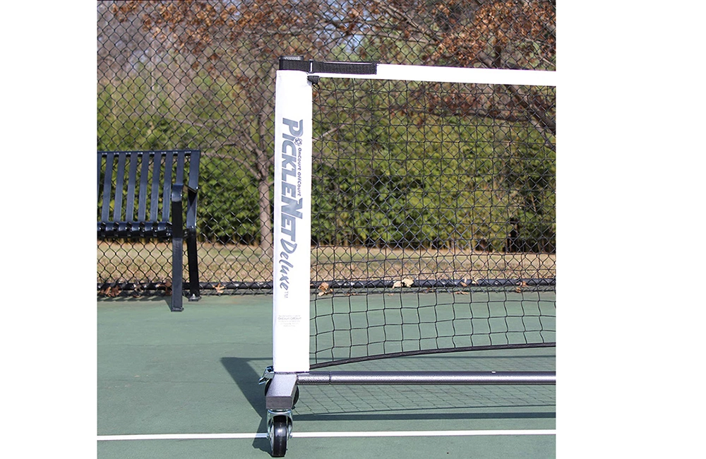 A portable court net has a white side support and a wheeled base.