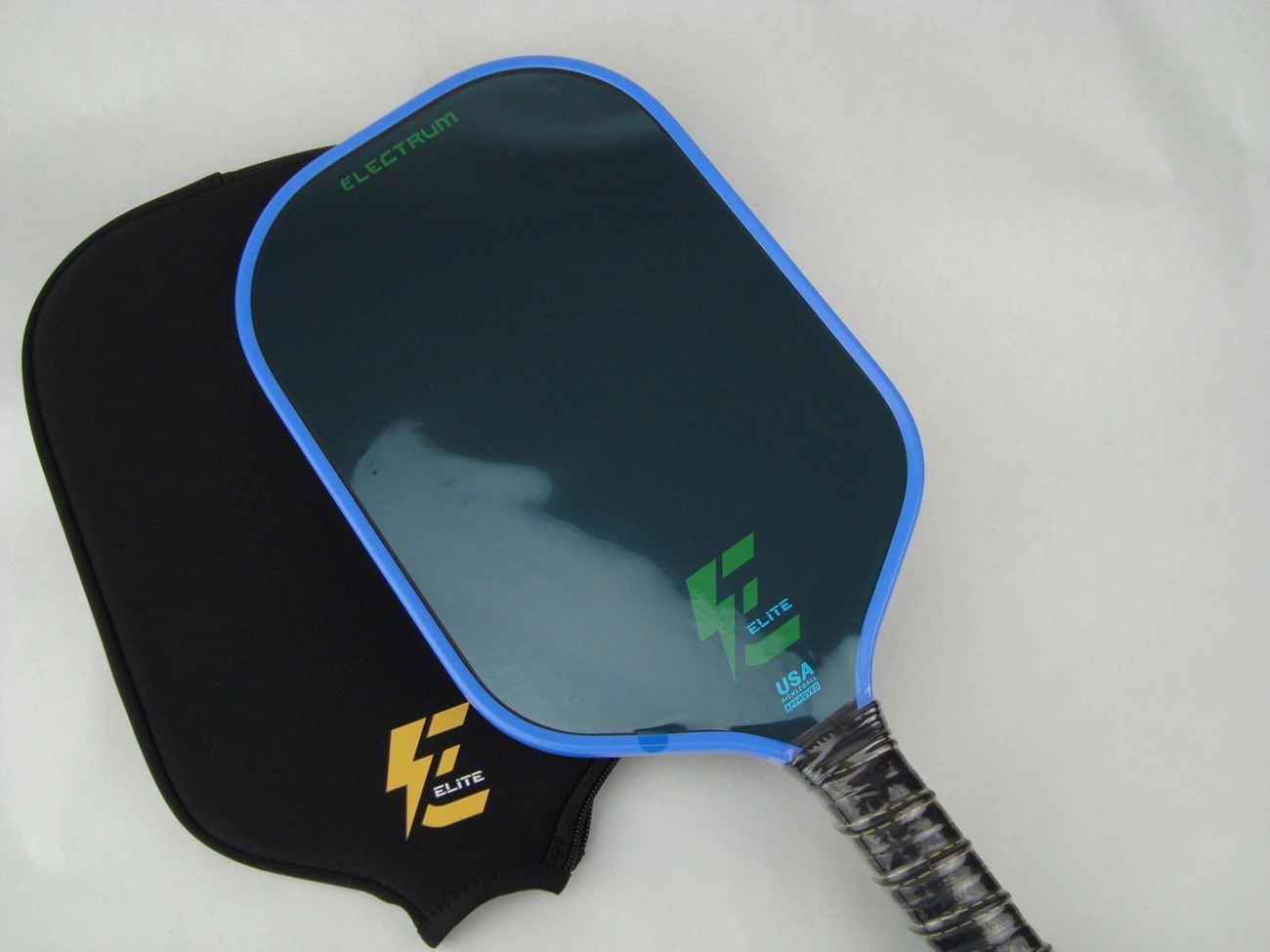 A blue-edged paddle lies on a black cover.