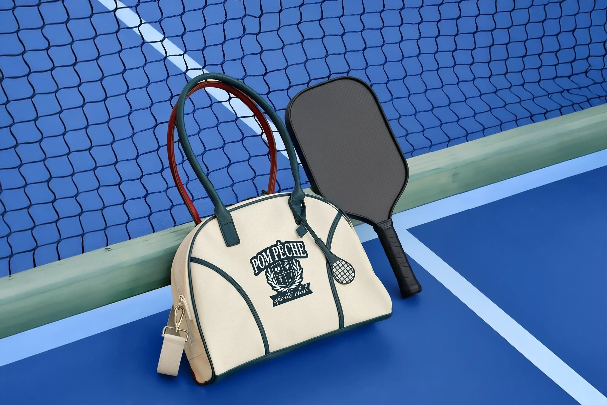 A pickleball bag and gear rest on a wooden bench.